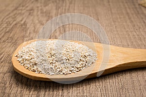 Oat cereal grain. Grains in wooden spoon. Rustic.