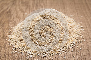 Oat cereal grain. Pile of grains on the wooden table. Selective