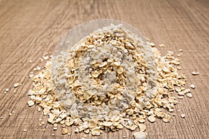 Oat cereal grain. Pile of grains on the wooden table. Selective