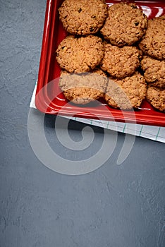 Oat cookies on dish over gray background. From above.