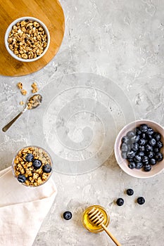 Oat flakes and berries granola glass on table background top view