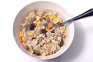 Oat flakes for breakfast in a bowl with spoon