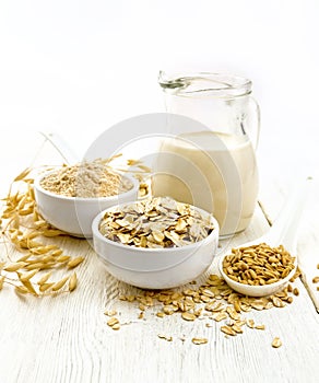 Oat flakes with flour and milk on white board