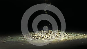 Oat flakes in a pile on a wooden board