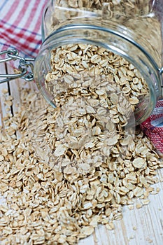 Oat flakes spilling from the glass jar