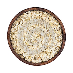 Oat flakes in wooden bowl isolated on white background. Top view