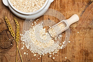 Oat flakes with a wooden spoon