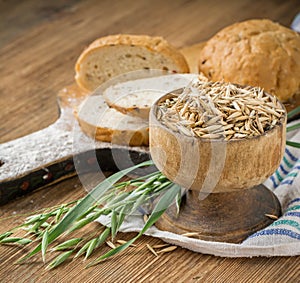 Oat flour, grain oats, oat bread on wooden