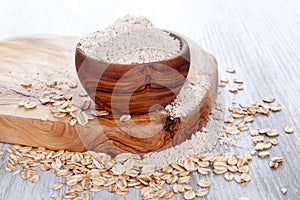 Oat flour in wooden bowl.