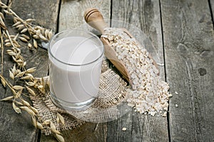 Oat milk alternative on rustic wood background