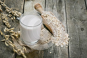 Oat milk alternative on rustic wood background photo