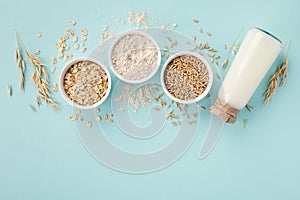 Oat milk, flour, dry flakes and whole grains top view. Set from organic oat products for vegetarian and healthy food