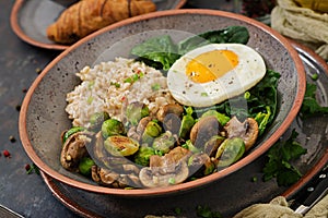 Oat porridge, egg and salad of baked vegetables - mushrooms and Brussels sprouts.