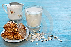 Oat snacks, a glass of milk on a blue table