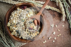 Oat and whole wheat grains flake in wooden bowl