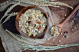 Oat and whole wheat grains flake in wooden bowl