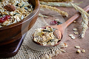 Oat and whole wheat grains flake in wooden bowl