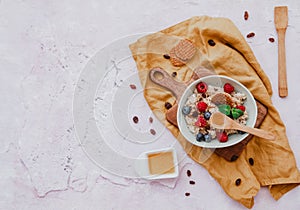 Oatmeal with berries in bowl on blue backgroundblue background,