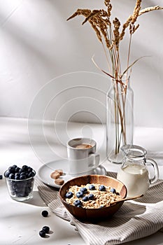 Oatmeal with blueberries, milk and cup of coffee