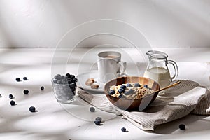 Oatmeal with blueberries, milk and cup of coffee