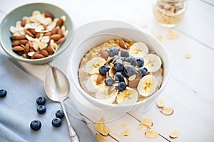 oatmeal bowl with banana slices, blueberries, and almond slivers