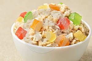 Oatmeal breakfast bowl. Organic healthy food with candied fruit