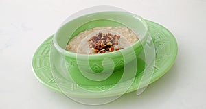 Oatmeal Breakfast with Chopped Pecans and Maple Syrup
