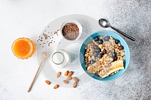 Oatmeal or breakfast oats porridge with fruits, flax seeds, honey