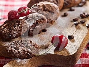 Oatmeal chocolate cookies with coffee grains and cherry. Sun flare