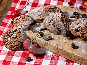 Oatmeal chocolate cookies with coffee grains and cherry. Sun flare