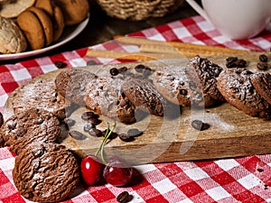 Oatmeal chocolate cookies with coffee grains and cherry. Sun flare