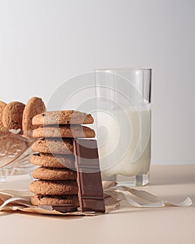 Oatmeal cookies with chocolate chunks and milk in a glass. Delicious healthy breakfast