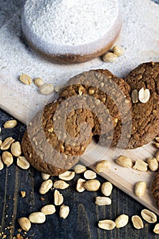 oatmeal cookies with peanuts on a black wooden table