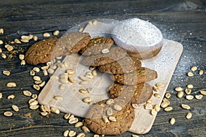 oatmeal cookies with peanuts on a black wooden table