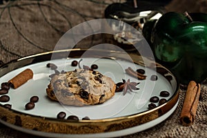 Oatmeal cookies with raisins on a saucer with a gold border