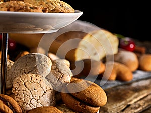 Oatmeal cookies ,rolled cake on tier cake stand with cherry