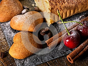 Oatmeal cookies ,rolled cake on tier cake stand with cherry