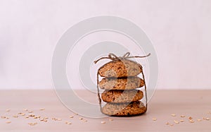 Oatmeal cookies are tied with craft thread. Healthy food for breakfast or a snack. Side view. Copy space.