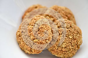 Oatmeal cookies on a white plate. Healthy food for breakfast or a snack. Close up. Soft focus