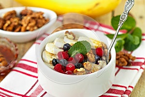 Oatmeal with fresh berries, bananas nuts and honey. Healthy Breakfast