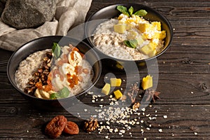 Oatmeal with fresh mango pieces, banana, dried apricots and walnuts, cooked in milk and decorated with mint chanterelles.