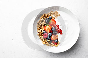 Oatmeal or granola with greek yogurt and  fresh berries, view from above