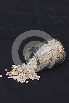 Oatmeal in a jar on a black background. Healthly food