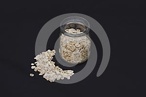 Oatmeal in a jar on a black background. Healthly food