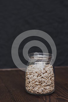 Oatmeal in a jar on a black background. Healthly food