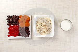 Oatmeal with milk and dried fruit. Useful and healthy breakfast. light background