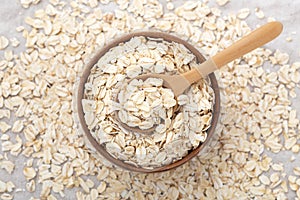 Oatmeal, oat cereal in wood bowl with spoon