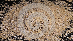 Oatmeal. Oat flakes. Close-up rotating. Dry oat flakes grains background, close up rotation loopable top view.