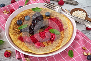 Oatmeal pancake with pureed berries