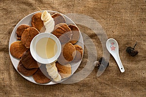 Oatmeal pancakes with bananan and honey on sackcloth, healthy food, horizontal view from above, close-up photo